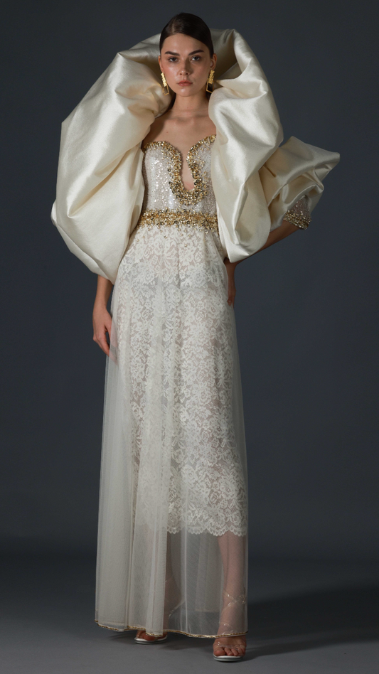 Ivory off-shoulder lace evening gown with gold beadwork and cape by Barrage Paris