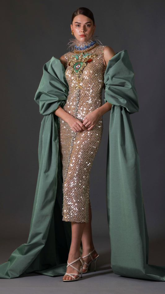 Gold sequin evening gown with feathered neckline and emerald overlay by Barrage Paris